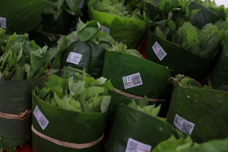 Food products wrapped in leaves at a Cambodian market.
