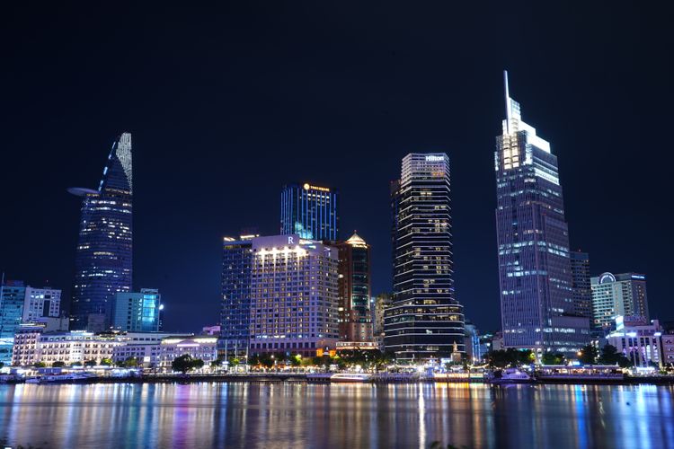 Vietnamese business district illuminated at night.