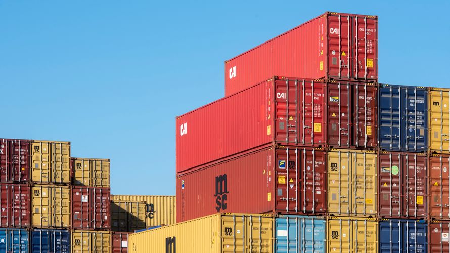 Shipping containers stacked in a logistics area.
