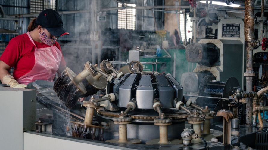 Worker manufacturing shoes in a factory in Cambodia.