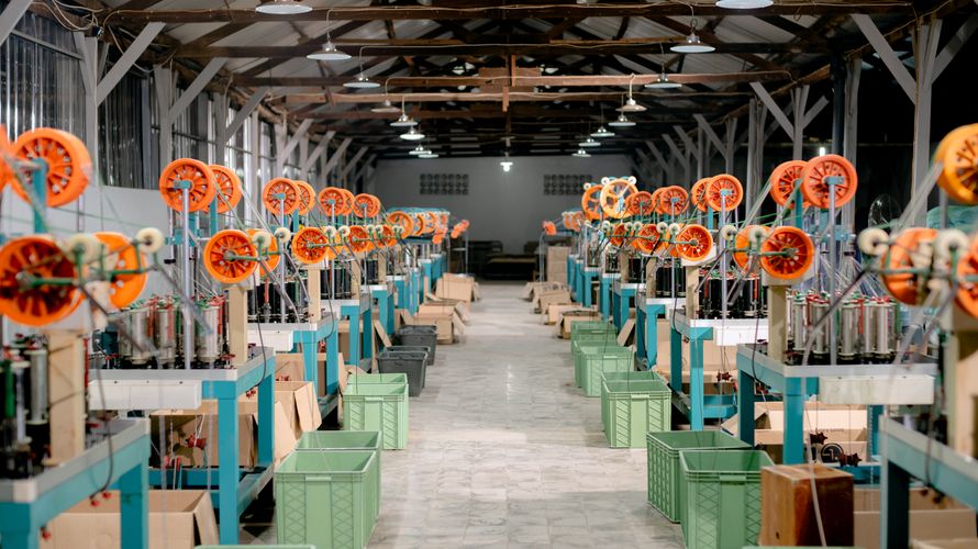Industrial machinery inside a textile factory in Cambodia.