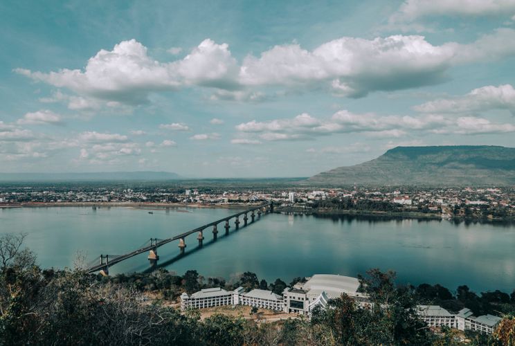 View of the Mekong River and a bridge crossing a city in Laos.