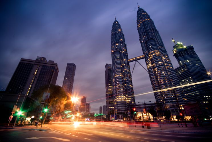 Petronas Towers illuminated in Kuala Lumpur’s business district.